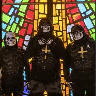 The three masked members of Bloodlined standing before stained glass