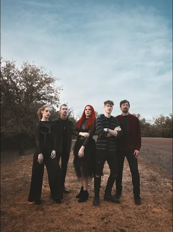 The members of Drive Thru Society standing together outdoors